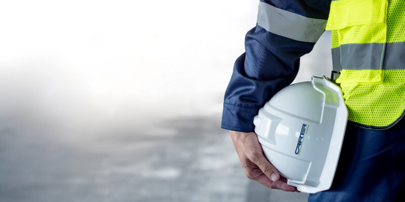 An image of an engineer focused on his hard hat